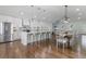 Open-concept kitchen with a large island and stainless steel appliances next to a dining table set for eight at 225 Valley Dr, Roswell, GA 30075