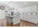 Stylish kitchen featuring a large island with barstool seating, stainless steel appliances, and bright white cabinetry at 225 Valley Dr, Roswell, GA 30075