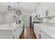 A modern kitchen with white cabinetry, gray backsplash, and stainless steel appliances at 225 Valley Dr, Roswell, GA 30075