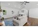 Sunlit living room featuring hardwood floors, a vaulted ceiling, and comfortable seating arrangement with stylish decor at 225 Valley Dr, Roswell, GA 30075