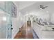Open-concept living space with hardwood floors, a vaulted ceiling, and views of the kitchen and dining area at 225 Valley Dr, Roswell, GA 30075