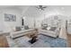 Spacious living room with hardwood floors, vaulted ceiling, and stylish furniture, connecting to the kitchen and dining at 225 Valley Dr, Roswell, GA 30075