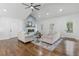 Inviting living area with hardwood floors, a fireplace feature wall, and ample natural light from surrounding windows at 225 Valley Dr, Roswell, GA 30075