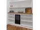 A pantry with shelving, wooden countertops, beverage refrigerator, and subway tile backsplash at 225 Valley Dr, Roswell, GA 30075