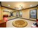Basement with round rug, mirrored wall, exercise balls and piano create flexible space for multiple uses at 50 S Underwood Dr, Covington, GA 30016