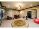 Basement with round rug, piano, stairs and arched doorways create flexible space for multiple uses at 50 S Underwood Dr, Covington, GA 30016
