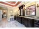 Spacious bathroom featuring granite counters, dark wood cabinets, and decorative mirrors at 50 S Underwood Dr, Covington, GA 30016