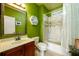 Bright bathroom with a tiled shower-tub combination and a modern sink and vanity at 50 S Underwood Dr, Covington, GA 30016