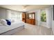 Bright bedroom with large windows, neutral walls, and classic wood furniture at 50 S Underwood Dr, Covington, GA 30016