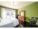 Cozy bedroom with hardwood floors, a dresser, and french doors opening to the outside at 50 S Underwood Dr, Covington, GA 30016