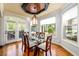 Elegant dining room with hardwood floors, a bay window, and access to an outdoor deck at 50 S Underwood Dr, Covington, GA 30016
