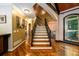 A home entryway showcasing hardwood floors, staircase with iron spindles, and a large window at 50 S Underwood Dr, Covington, GA 30016