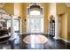 Grand foyer with high ceilings, decorative columns, and elegant tile inlay on dark hardwood flooring at 50 S Underwood Dr, Covington, GA 30016
