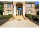 Grand entrance with stone steps leading to a front door framed by stately columns and brick facade at 50 S Underwood Dr, Covington, GA 30016