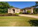 Beautiful brick home with manicured lawn, lush landscaping, and a circular driveway creating great curb appeal at 50 S Underwood Dr, Covington, GA 30016