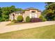 Stunning brick home featuring a well-manicured lawn, circular driveway, and vibrant landscaping elements at 50 S Underwood Dr, Covington, GA 30016