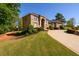 Elegant brick home with well-maintained lawn and landscaping featuring mature trees and shrubs enhancing its appeal at 50 S Underwood Dr, Covington, GA 30016