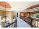Second floor hallway with wrought iron railing, natural light, and decorative ceilings at 50 S Underwood Dr, Covington, GA 30016