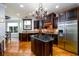 Spacious kitchen boasts a central island, dark wood cabinets, stainless steel appliances, and hardwood floors at 50 S Underwood Dr, Covington, GA 30016