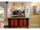 Stylish kitchen pass-through area with granite countertops, dark wood cabinets, and decorative lighting at 50 S Underwood Dr, Covington, GA 30016