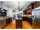 Bright and open kitchen featuring a central island, dark wood cabinets, granite countertops, and a breakfast area at 50 S Underwood Dr, Covington, GA 30016