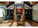Living room with a stone fireplace, built-in shelving, and a coffered ceiling design at 50 S Underwood Dr, Covington, GA 30016