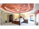 Main bedroom with furniture, carpet floors, and a trey ceiling with yellow tones at 50 S Underwood Dr, Covington, GA 30016