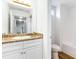 Bright bathroom featuring a vanity with a large mirror and a toilet with a bathtub at 8405 Military Way, Douglasville, GA 30134