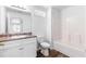 A bright bathroom featuring a shower and bath combo, with an attractive granite vanity top at 8405 Military Way, Douglasville, GA 30134