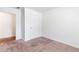 This bedroom features a plush carpet and a door leading to another room at 8405 Military Way, Douglasville, GA 30134
