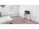 Cozy bedroom with a twin bed, plush carpet and a window view of the outdoors at 8405 Military Way, Douglasville, GA 30134