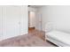 A bedroom featuring a white bed, closet, and connecting door, ideal for or guests at 8405 Military Way, Douglasville, GA 30134