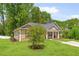 Beautiful single-Gathering home with a landscaped yard, cozy front porch, and inviting curb appeal set amid lush greenery at 8405 Military Way, Douglasville, GA 30134