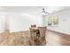 Living space boasting wood floors, a large window, a ceiling fan, and neutral paint for a cozy atmosphere at 8405 Military Way, Douglasville, GA 30134