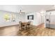 Inviting living area featuring wood floors, natural light, a stainless steel refrigerator, and a modern ceiling fan at 8405 Military Way, Douglasville, GA 30134