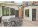 Inviting back deck with a patio set, connected to the home's screened-in porch and brick exterior at 918 Guinevere Way, Lilburn, GA 30047
