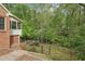 Charming two-story home featuring a fenced yard with lush trees and garden at 918 Guinevere Way, Lilburn, GA 30047