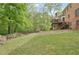 Enjoy a lush green lawn, mature trees, and a beautiful brick home exterior at 918 Guinevere Way, Lilburn, GA 30047