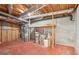 Unfinished basement space featuring exposed ductwork and a water heater at 918 Guinevere Way, Lilburn, GA 30047