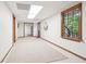 Finished basement hallway with carpet, wood trim, and a glass paneled door leading to the outside at 918 Guinevere Way, Lilburn, GA 30047