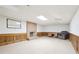 Spacious basement featuring a brick fireplace, paneled walls, and ample room for customization at 918 Guinevere Way, Lilburn, GA 30047