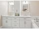 Bright bathroom features a double sink vanity, marble countertops, white cabinets, and modern fixtures at 918 Guinevere Way, Lilburn, GA 30047