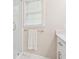 Bright bathroom features glass shower, a window with natural light, and modern fixtures at 918 Guinevere Way, Lilburn, GA 30047