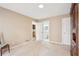 A beige bedroom with 2 doors, carpet flooring, and visible connections to a bathroom and closet at 918 Guinevere Way, Lilburn, GA 30047