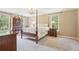 Four-poster bed and matching furnishings create an inviting and stylish bedroom retreat at 918 Guinevere Way, Lilburn, GA 30047