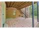 Spacious brick patio with an exposed wood beam ceiling and stairs leading to an upper level at 918 Guinevere Way, Lilburn, GA 30047