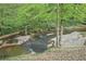 Scenic view of a small creek surrounded by lush greenery and mature trees at 918 Guinevere Way, Lilburn, GA 30047