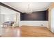 Dining room showing hardwood floors, wainscoting, and an open view into the living room at 918 Guinevere Way, Lilburn, GA 30047