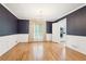 Elegant dining room with hardwood floors, wainscoting, and a modern chandelier at 918 Guinevere Way, Lilburn, GA 30047