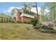 A fenced backyard with a well-manicured lawn and mature landscaping at 918 Guinevere Way, Lilburn, GA 30047